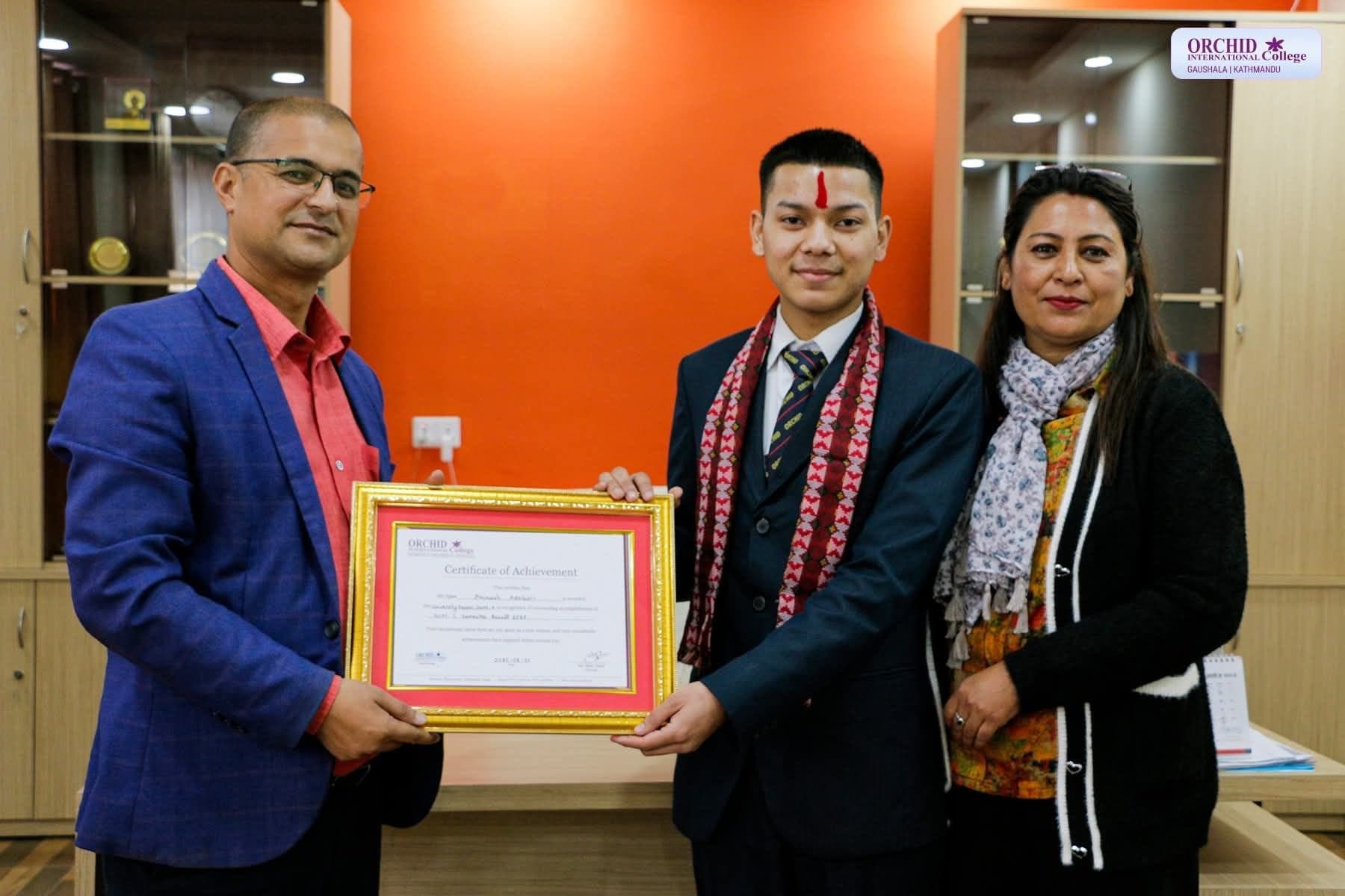Abinash receiving the certificate of achievement from college staff